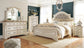 Realyn  Upholstered Panel Bed With Mirrored Dresser, Chest And Nightstand